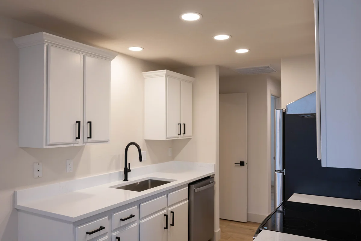 Finished kitchen reconstruction with white cabinets